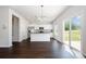 Bright, open kitchen features stainless appliances, gray countertops, and dark wood flooring at 3001 Sadler Woods Ln, Charlotte, NC 28214