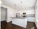 Modern kitchen showcasing white cabinetry, a gray countertop island, and sleek stainless steel appliances at 3001 Sadler Woods Ln, Charlotte, NC 28214