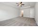 Spacious main bedroom with neutral carpet, ceiling fan and tray ceiling at 3001 Sadler Woods Ln, Charlotte, NC 28214