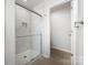 Shower with glass doors and neutral tile surround at 3001 Sadler Woods Ln, Charlotte, NC 28214