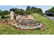 Elegant entrance to 'The Farm at Ingleside' community with beautiful landscaping and water features at 320 Secretariat Dr, Iron Station, NC 28080