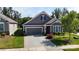 Beautiful home with a well-manicured lawn, lovely landscaping, and a two-car garage at 320 Secretariat Dr, Iron Station, NC 28080