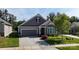 Charming single-Gathering home features a manicured lawn, gray siding and an attached two-car garage at 320 Secretariat Dr, Iron Station, NC 28080