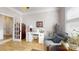 Bright home office with wood floors, a white desk, and a comfortable chair at 320 Secretariat Dr, Iron Station, NC 28080
