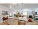 Bright, open-concept kitchen with island, pendant lighting, and views of the living and dining areas at 320 Secretariat Dr, Iron Station, NC 28080
