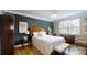 Comfortable main bedroom featuring a queen-sized bed, dark accent wall, hardwood floors and neutral colors at 320 Secretariat Dr, Iron Station, NC 28080