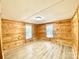 Bedroom showcasing natural wood paneling and newer flooring, bright with natural light at 325 Scaley Bark Dr, Salisbury, NC 28147
