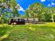 Charming ranch-style home with black trim, inviting deck and ramp access on a lush, tree-lined lot at 325 Scaley Bark Dr, Salisbury, NC 28147