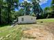 Ranch-style home exterior with ramp access on a sunny day, nestled in a lush, green, tree-lined yard at 325 Scaley Bark Dr, Salisbury, NC 28147