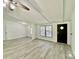 Bright, open-concept living room with modern floors, white walls, ceiling beams, and a black front door at 325 Scaley Bark Dr, Salisbury, NC 28147