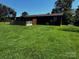 Exterior view of a home with a large, green, grassy backyard and back porch at 3375 Shepherd Rd, Maiden, NC 28650