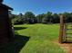 Exterior view of the property showing a lush green, open backyard and fencing at 3375 Shepherd Rd, Maiden, NC 28650