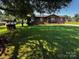 Charming single-story home with a well-maintained lawn, framed by a picturesque tree at 3375 Shepherd Rd, Maiden, NC 28650