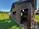 Rustic exterior view of the shed with adjacent fence and open field at 3375 Shepherd Rd, Maiden, NC 28650
