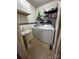Practical laundry room with a sink, washer, dryer, and overhead storage shelves at 3375 Shepherd Rd, Maiden, NC 28650