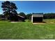 Exterior view of outbuildings on a large grassy lot at 3375 Shepherd Rd, Maiden, NC 28650