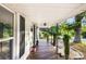 Charming front porch featuring black shutters, decorative plants, and wood flooring at 402 Ford St, Kannapolis, NC 28083