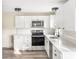 Contemporary kitchen boasting white cabinets, stainless steel appliances, and updated countertops at 402 Ford St, Kannapolis, NC 28083