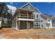 New construction home showcasing a covered front porch, large windows, and neutral gray siding at 4041 Grommet Ct, Matthews, NC 28105