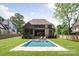 Beautiful backyard showcasing a modern pool and lush lawn at 412 Jefferson Dr, Charlotte, NC 28270