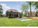 Expansive backyard featuring a modern pool with a built-in spa, surrounded by lush greenery and a manicured lawn at 412 Jefferson Dr, Charlotte, NC 28270