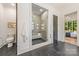 Bathroom with a glass-enclosed shower, a toilet and a door leading to the bedroom at 412 Jefferson Dr, Charlotte, NC 28270