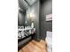 Modern powder room features a marble sink, black fixtures, and wood floors at 412 Jefferson Dr, Charlotte, NC 28270