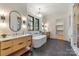 Elegant bathroom boasts double vanity, soaking tub, walk-in closet, and black floors at 412 Jefferson Dr, Charlotte, NC 28270