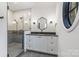 Stylish bathroom features a glass-enclosed shower and floating vanity with elegant mirror at 412 Jefferson Dr, Charlotte, NC 28270