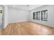 Light-filled bedroom features hardwood floors, trim package, and large windows with a view of the outdoors at 412 Jefferson Dr, Charlotte, NC 28270