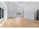 Open bedroom featuring hardwood floors, dormered walls with a ceiling fan and a door to closet at 412 Jefferson Dr, Charlotte, NC 28270