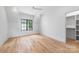 Spacious bedroom with hardwood floors, a ceiling fan, large windows and a walk-in closet that offers comfort at 412 Jefferson Dr, Charlotte, NC 28270