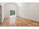 Bright, empty bedroom features large windows, hardwood flooring and white walls at 412 Jefferson Dr, Charlotte, NC 28270