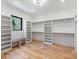 Walk-in closet with custom shelving and hardwood floors for ample storage at 412 Jefferson Dr, Charlotte, NC 28270