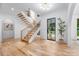 Bright foyer featuring hardwood floors, modern staircase, contemporary chandelier, and a view of the outdoors at 412 Jefferson Dr, Charlotte, NC 28270