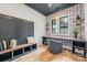 Bright home office featuring a functional built-in desk, decorative wallpaper, and hardwood floors at 412 Jefferson Dr, Charlotte, NC 28270