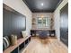 Inviting home office with custom built-ins, designer wallpaper, and stylish lighting fixture at 412 Jefferson Dr, Charlotte, NC 28270