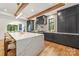 Stylish kitchen featuring a large marble island, dark cabinetry, stainless steel appliances, and hardwood floors at 412 Jefferson Dr, Charlotte, NC 28270
