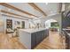Modern kitchen with a large island, dark cabinets, hardwood floors, and open sight lines into the living areas at 412 Jefferson Dr, Charlotte, NC 28270