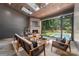 Inviting living room with a fireplace, skylights, wood ceiling, and a seamless transition to the outdoor pool area at 412 Jefferson Dr, Charlotte, NC 28270