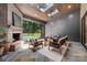 Inviting screened-in living room with a fireplace, skylights, and views of the outdoor pool at 412 Jefferson Dr, Charlotte, NC 28270
