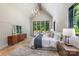 Main bedroom boasts vaulted ceiling, natural light, seating area, and wood floors at 412 Jefferson Dr, Charlotte, NC 28270