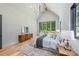 Spacious main bedroom featuring a vaulted ceiling, chandelier, large windows and hardwood floors at 412 Jefferson Dr, Charlotte, NC 28270