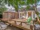 Tranquil backyard oasis with wooden deck, gazebo, and mature trees at 4801 Pennant Pl, Charlotte, NC 28212