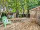 Serene backyard featuring a wooden deck, shed, and lush greenery at 4801 Pennant Pl, Charlotte, NC 28212