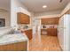 Well-lit kitchen with wooden cabinets, granite countertops, stainless steel sink and white appliances at 4801 Pennant Pl, Charlotte, NC 28212