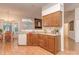 Well-lit kitchen with wood cabinets, bright laminate countertops, and open layout to the dining area at 4801 Pennant Pl, Charlotte, NC 28212