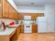 Functional kitchen with ample cabinetry, white appliances, and laminate countertops at 4801 Pennant Pl, Charlotte, NC 28212