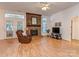 Cozy living room with brick fireplace, ceiling fan, and french doors to the back at 4801 Pennant Pl, Charlotte, NC 28212