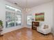 Bright living room with large windows, hardwood floors, chandelier, and neutral decor at 4801 Pennant Pl, Charlotte, NC 28212